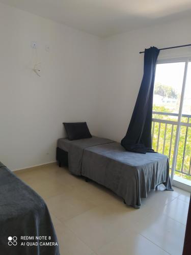 a bedroom with a bed and a balcony at Refúgio, paraquedismo, balão, 130 km de São Paulo in Pôrto Feliz
