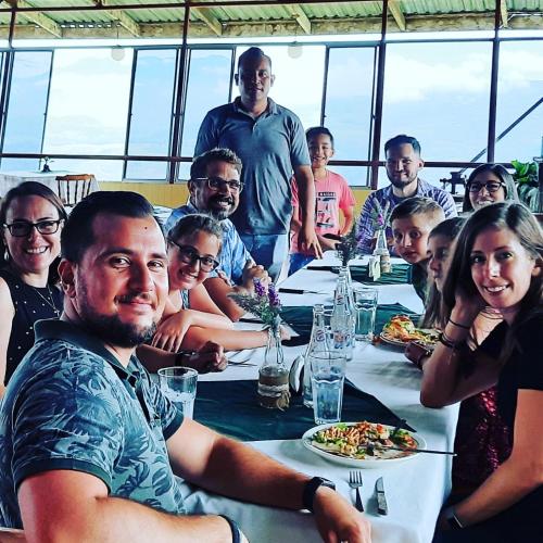 a group of people sitting around a long table at Pochotel Natural in Turrialba