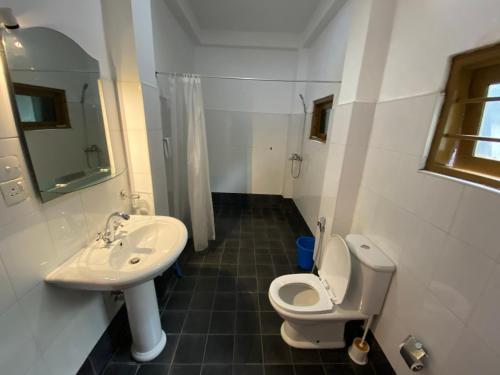 a bathroom with a toilet and a sink at Una Beach Hotel & OLU Cafe in Unawatuna