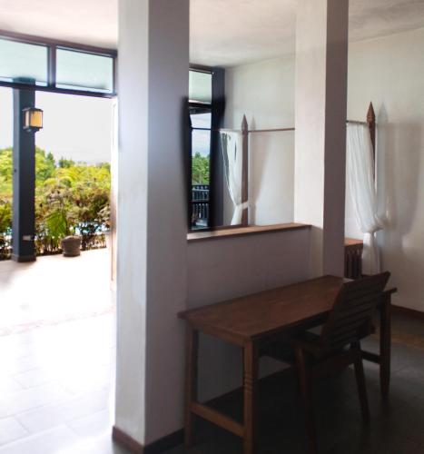 a dining room with a table and a window at Punta Duarte Garden Inn in Los Duarte