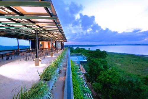 a building with a view of the water at The Lake Forest Hotel in Anuradhapura