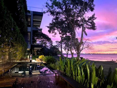 a patio with a view of the ocean at sunset at The Lake Forest Hotel in Anuradhapura