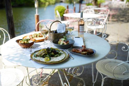 a table with plates of food and glasses of wine at The Swan Hotel and Spa in Newby Bridge