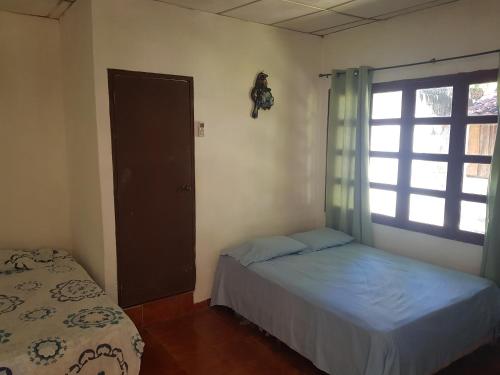 a small bedroom with a bed and a window at Rancho villas de alicia in La Paz