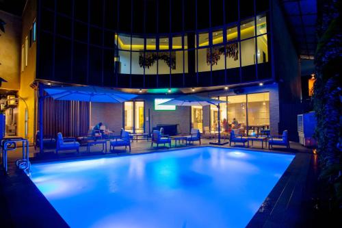 a large swimming pool in front of a building at D'avenue Boutique Hotel Accra in Accra