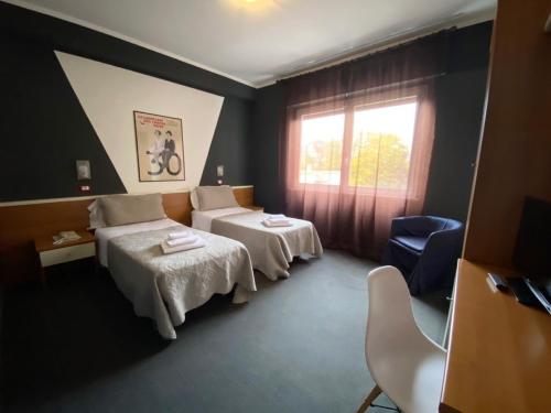 Postel nebo postele na pokoji v ubytování Hotel Santin