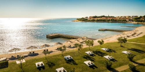 an aerial view of a beach with chairs and the water at Aminess Vival Maestral Hotel in Novigrad Istria