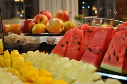 a bunch of fruit on a table with apples at Curitiba Palace Hotel in Curitiba