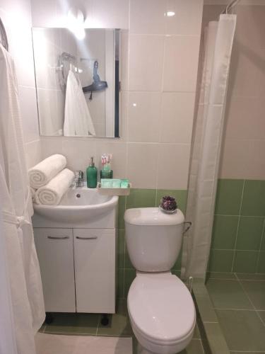 a bathroom with a white toilet and a sink at Апартаменты бизнесс-класса in Moscow