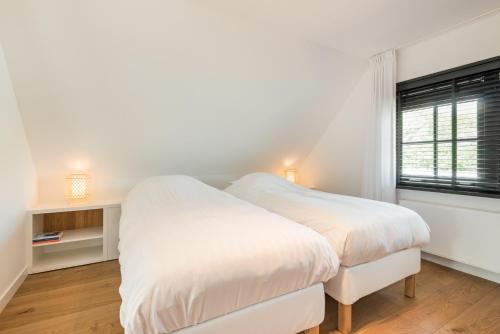 Tempat tidur dalam kamar di Goudkust 4 'Schoorls Geluk'