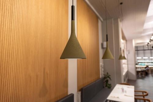 aendant light hanging from a wall in a room at Dionisos Hotel in Larisa