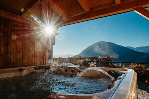 a hot tub with a view of the mountains at Apartment Judith - Gallhof in Vollan