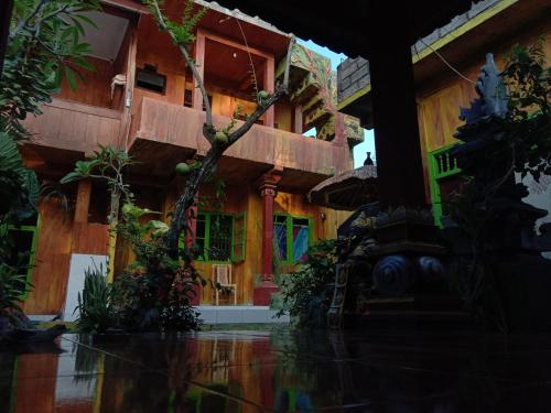 an outside view of a building with trees and plants at Pondok Diana Arta in Jasri