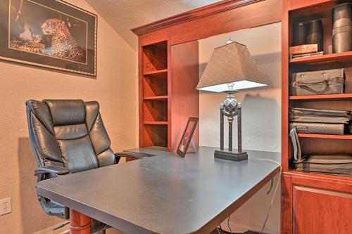 a desk with a lamp and a chair in a room at Elegant Valrico Home about 15 Mi to Downtown Tampa! in Valrico