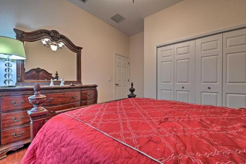 a bedroom with a red bed and a large mirror at Elegant Valrico Home about 15 Mi to Downtown Tampa! in Valrico