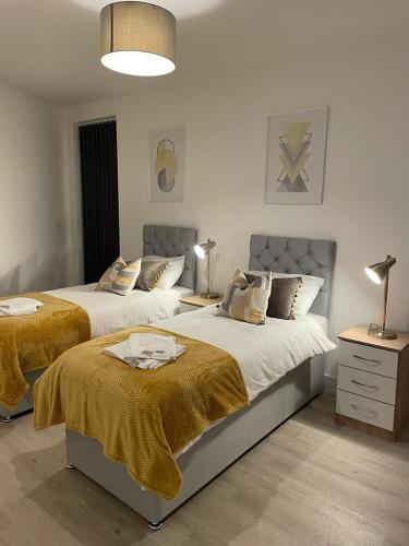 a bedroom with two beds and a lamp at Elevate at Fleet Heights Apartment Seven in Fleet