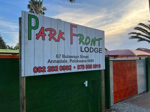 a sign for a park front lodge in front of a building at PARK FRONT LODGE in Polokwane