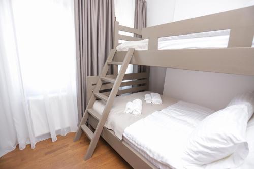 a bedroom with a bunk bed with two white towels at Nivalis Residence in Jahorina