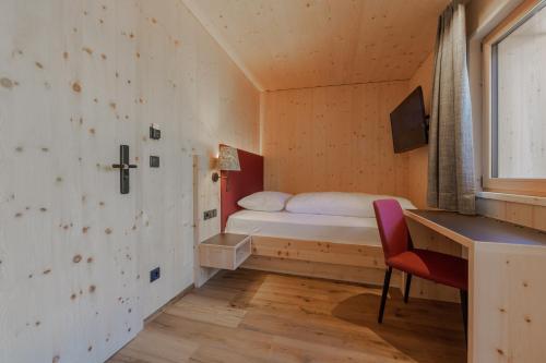 a small bedroom with a bed and a desk at Panorama in Sesto