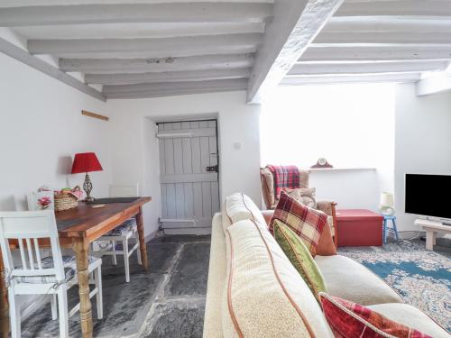 a living room with a couch and a table at 1 Hendom in Corwen