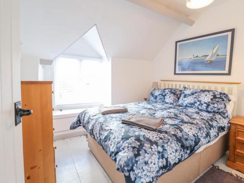 a bedroom with a bed and a window at 1 Hendom in Corwen