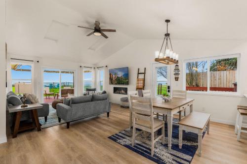 a living room with a table and a dining room at @ Marbella Lane – Wave House, Your Oceanfront Retreat! in Oak Harbor