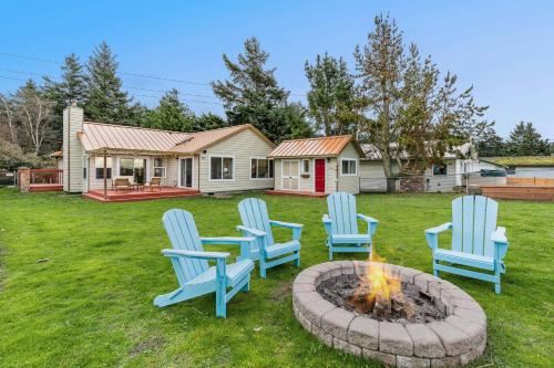 a group of blue chairs sitting around a fire pit at @ Marbella Lane – Wave House, Your Oceanfront Retreat! in Oak Harbor