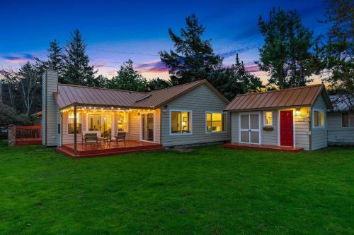a house with a porch with lights on it at @ Marbella Lane – Wave House, Your Oceanfront Retreat! in Oak Harbor