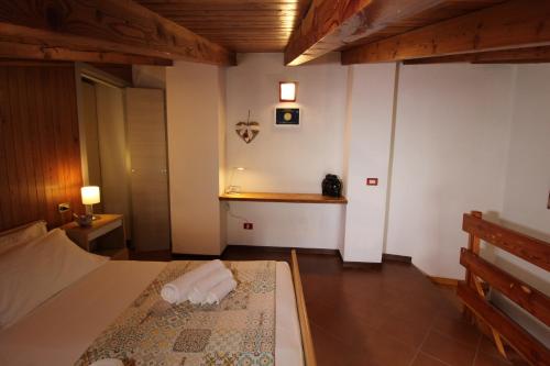 a bedroom with a bed with two towels on it at Ca' Marietta al Centro Storico in Borno