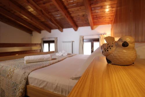 a bedroom with a bed with a vase on a table at Ca' Marietta al Centro Storico in Borno