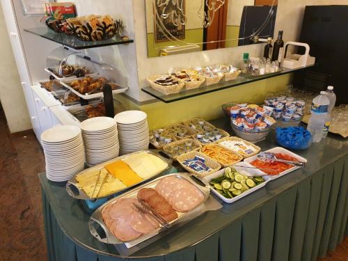 a buffet with many different types of food on a counter at Hotel Azalea in Baveno