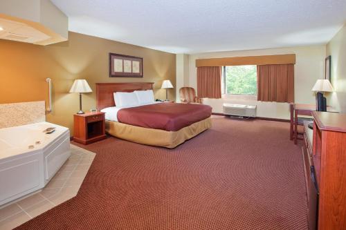 a large hotel room with a bed and a bathroom at University Inn in Boiling Springs