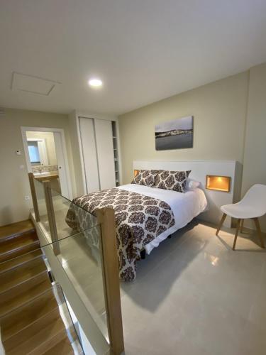 a bedroom with a large bed and a glass floor at Pousadas Mariñeiras,sl - AT "Camiño da Barca" in Muxia