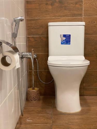 a white toilet in a bathroom with a shower at Moss Art Boutique Hotel in Baku