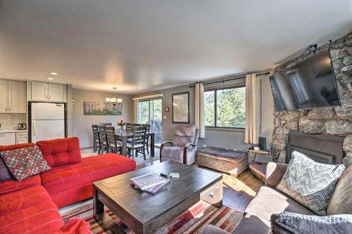 a living room with a red couch and a fireplace at Luxe Updated Home with Grill and Hot Tub 4 Mi to RMNP in Estes Park