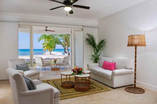 a living room with a couch and chairs and a table at Half Moon in Montego Bay