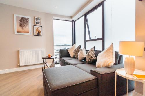 a living room with a couch and some windows at No Seven Harbour Side in Poole