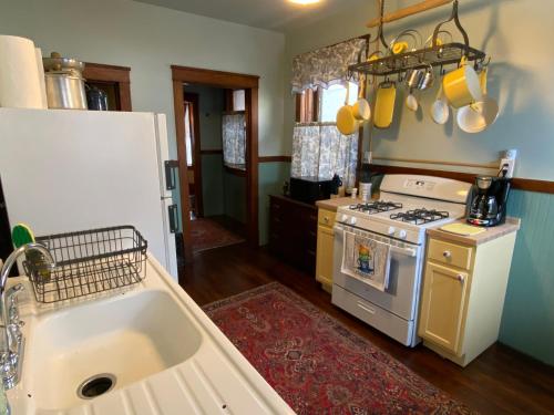 a kitchen with a sink and a stove at The Edmond an 1887 Arts & Crafts gem in Saint Joseph
