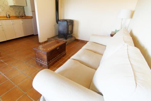 a living room with two white couches and a tv at Casas Arbillas in Arenas de San Pedro