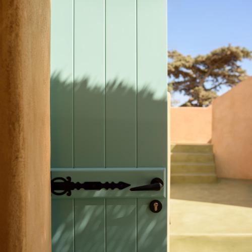 an open door with a glass wall with a staircase at Potamos Luxury House, Private Pool, Santorini in Éxo Goniá