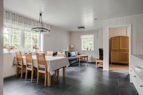 a kitchen and living room with a table and a couch at Solar Lake Cottage in Jönköping