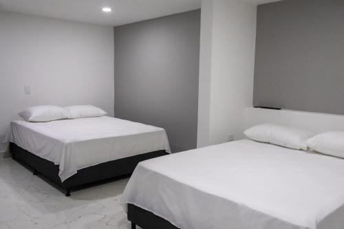 Uma cama ou camas num quarto em Nómada Hospedaje
