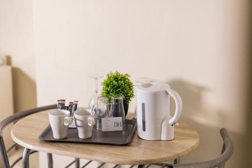 a table with a coffee maker and cups on it at Dunes Hotel in Whitley Bay