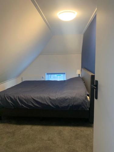 a bedroom with a bed in a attic at 'T Hûske 66 in Burum
