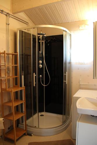a shower with a glass door in a bathroom at Lakeview Houses Sweden in Falun