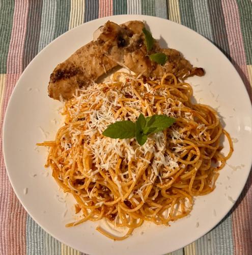 a plate of pasta with meat and cheese at Manta Stay Thoddoo, Maldives in Thoddoo