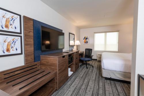 a hotel room with a bed and a flat screen tv at Comfort Inn & Suites in Carleton Place