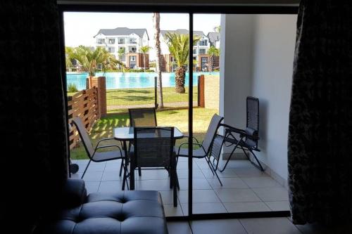 a view of a patio with a table and chairs at Crystal lagoon View 3Bed Apartment in Pretoria