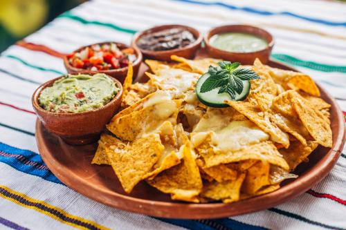 a plate of nachos and dips on a table at Eco-Hotel Mayachik in San Juan La Laguna