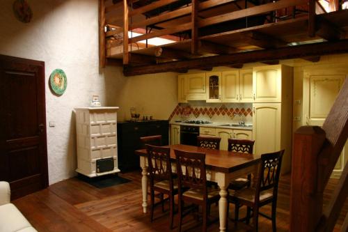 a kitchen with a table and chairs and a refrigerator at Casa del Vasaio in Tenno